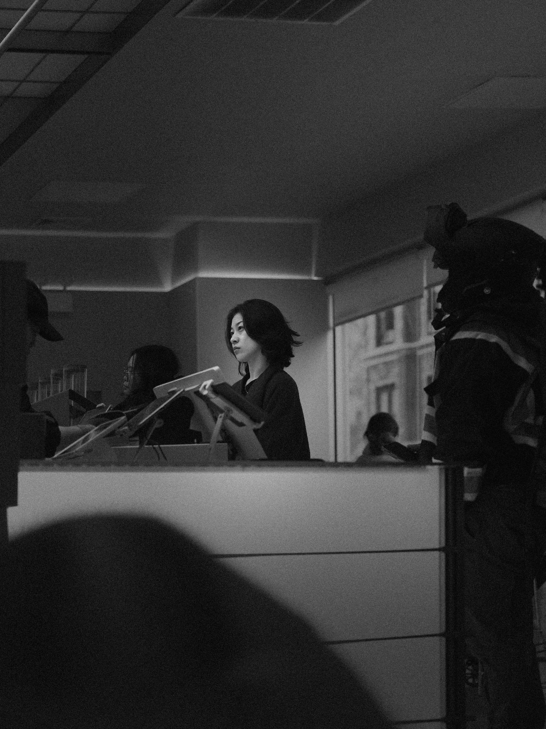 Black-and-white documentary frame inside a room